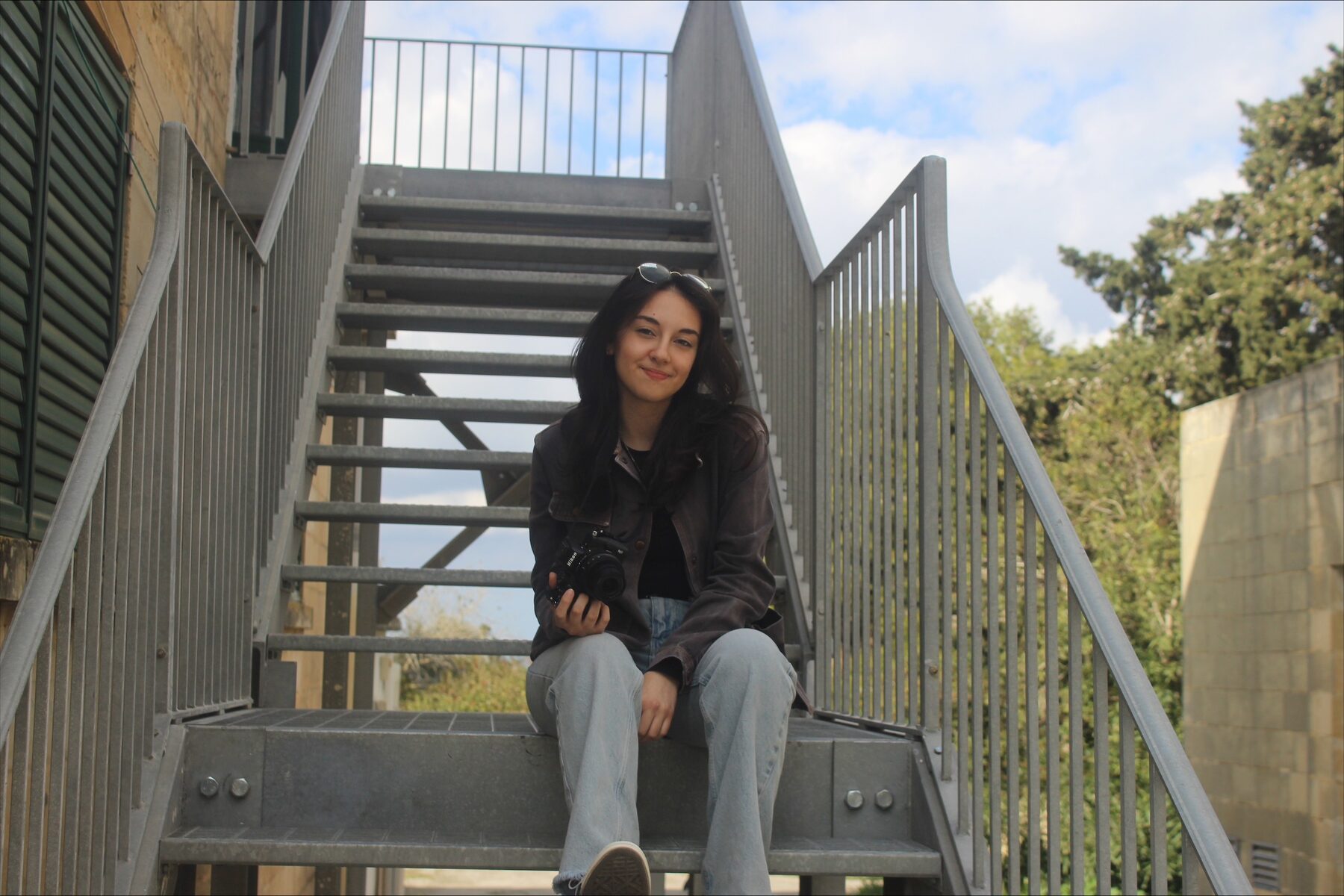 Fiorella sitting outdoors